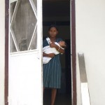 Girl And Baby At Clinic Door